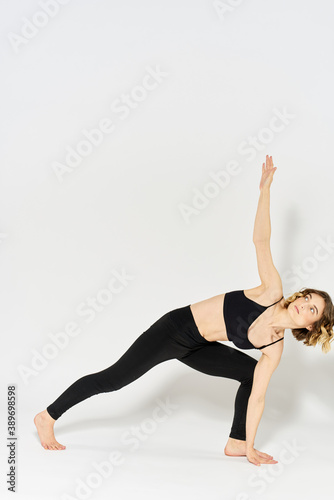 Woman in sportswear is engaged in fitness indoor gymnastics slim figure