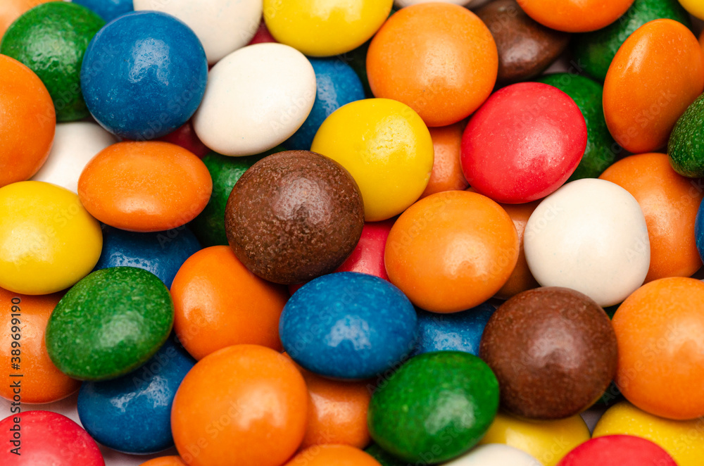 A large number of colorful candies on a white background, ready for sale A large number of colorful candies on a white background, ready for sale