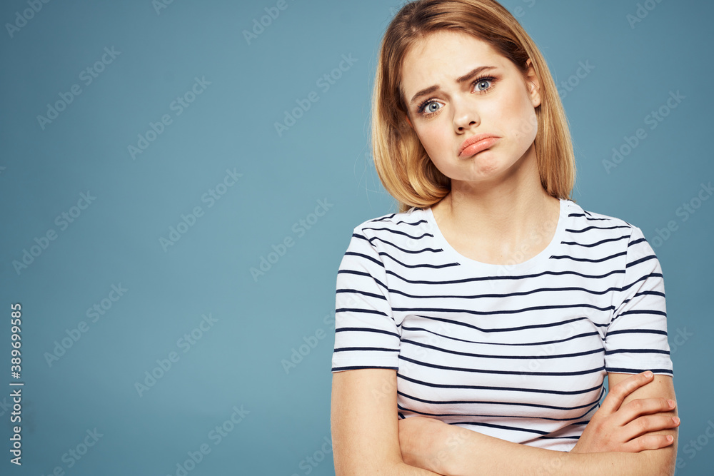 Obraz premium Upset woman emotions displeasure gestures with hands blue background