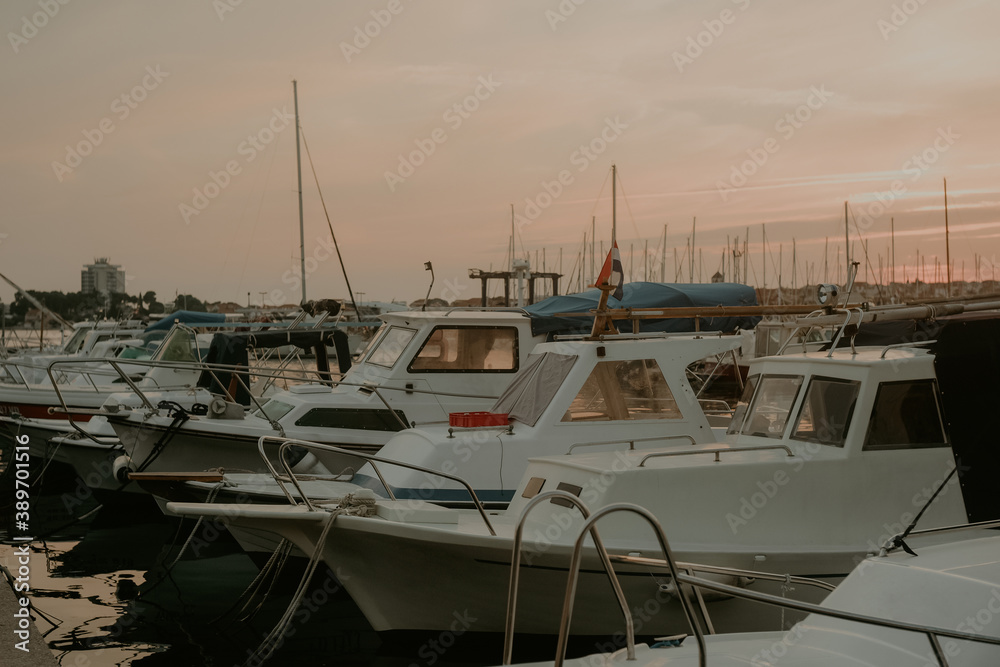 Fototapeta premium There are many yachts, boats and ships at sea. Marina at sunset.