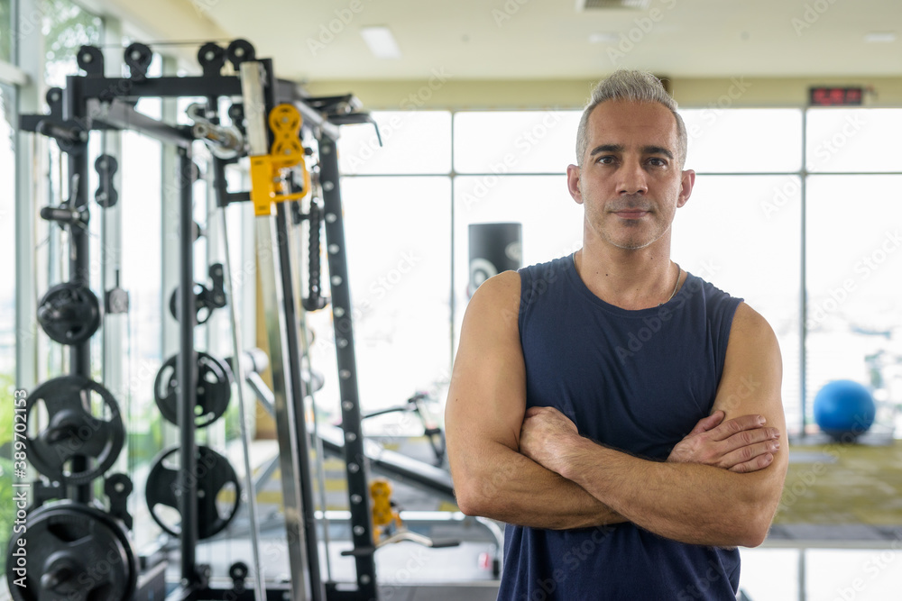 Mature handsome Persian man with arms crossed at the gym Mature handsome Persian man with arms crossed at the gym