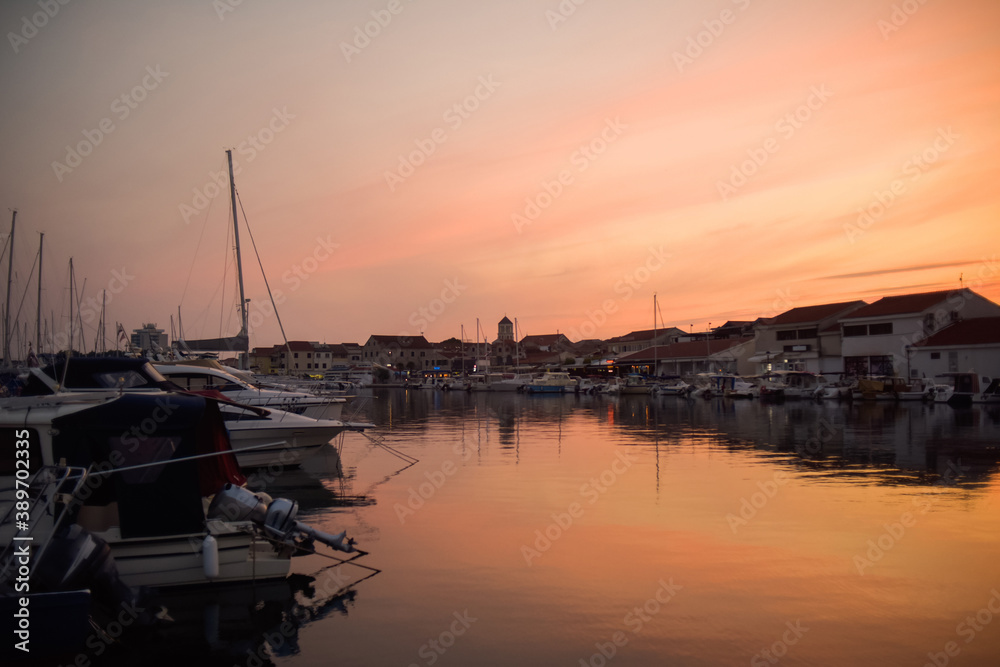 There are many yachts, boats and ships at sea. Marina at sunset. Vosice Croatia Gorgeous summer sunset by the ocean