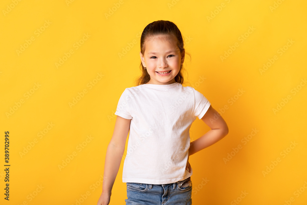 Smiling asian girl posing and looking at camera Smiling asian girl posing and looking at camera