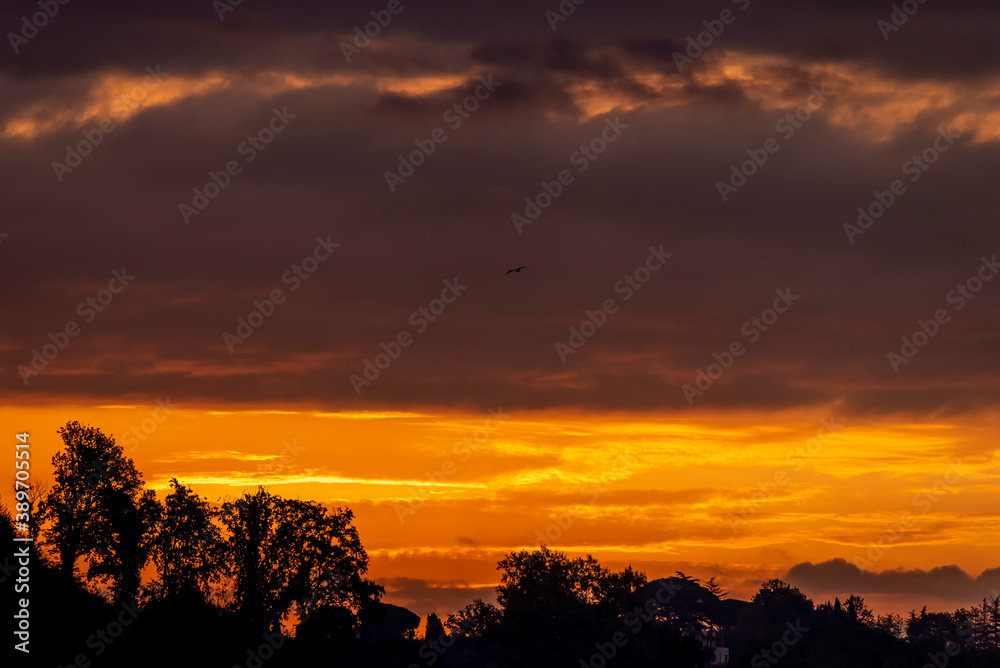 The colorful dawn of a new day over the Tuscan countryside, Italy