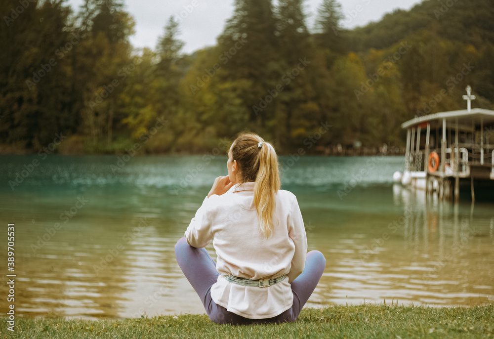 Nice mountain views at Plitvice Lakes Park. Croatia. Traveler girl sits and looks into the distance