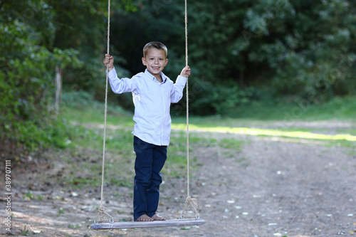 boy on swing on nature
