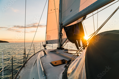Fototapeta Naklejka Na Ścianę i Meble -  Golden sunset over the ocean captured from a sailing yacht in the baltic sea