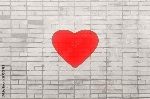 Big red heart on a gray brick wall. The concept of health and the struggle of doctors for the lives of patients