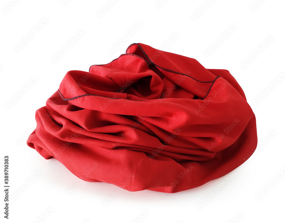 Front view of wrinkled red beach or bath towel isolated on white background. Red folded microfiber cloth isolated. Close up of red fleece blanket. Home textile accessories and Christmas decorations.