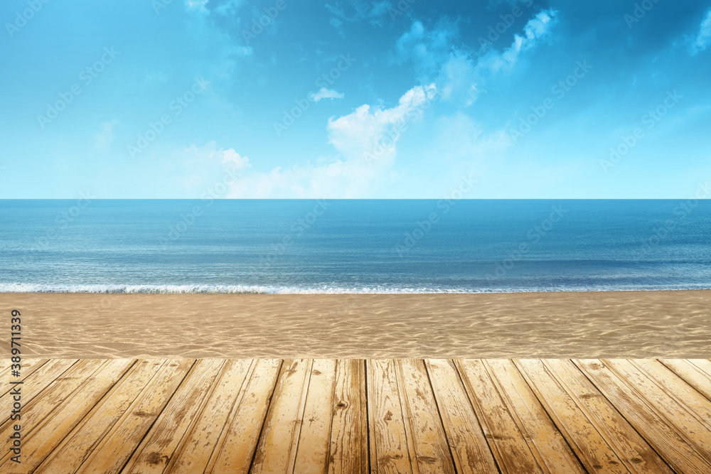 View of a beach with wooden floor and the sea in the background on a summer day