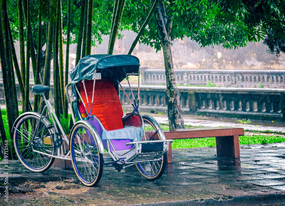 Fototapeta premium Vintage oriental bicycle empty Riksha cab street Ho Chi Minh city Taxi.