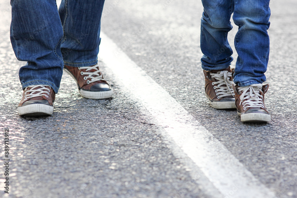 feet father and child walk along the road feet father and child walk along the road