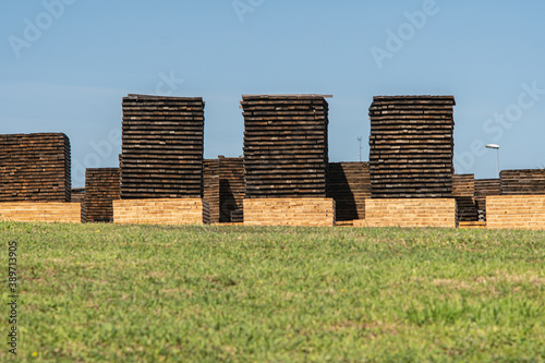 Stacks of wooden boards in a cooperage or barrel factory.