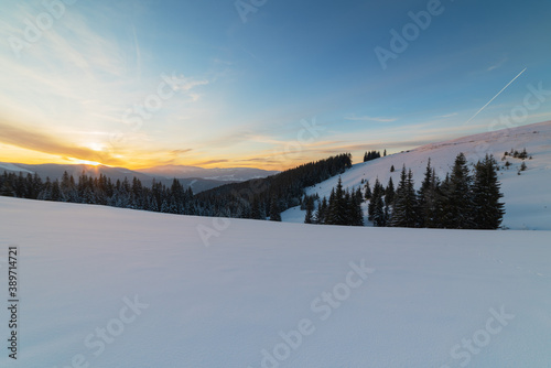 Severe winter on a mountain range in the Ukrainian Carpathian mountains with cozy houses and a magnificent view of the peaks of Hoverla and Petros