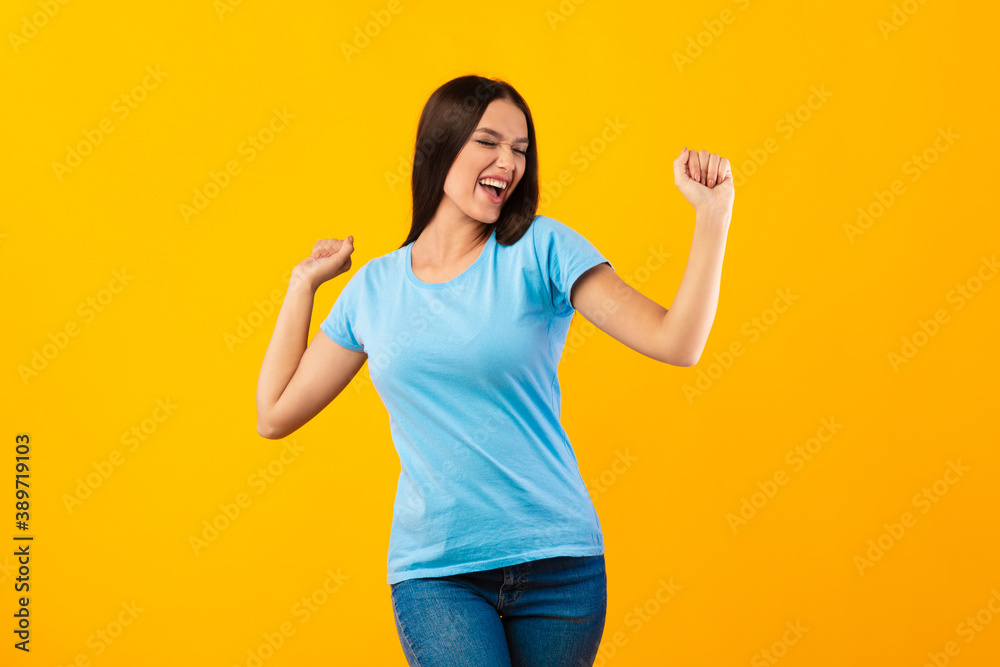 Smiling woman enjoying music and dancing at studio Smiling woman enjoying music and dancing at studio