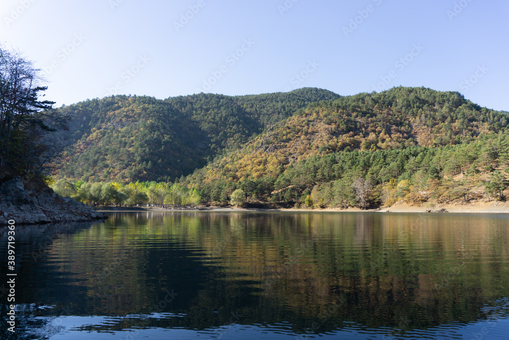 Reflections by the lake on a sunny autumn day