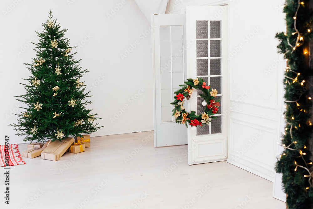 Fototapeta premium Christmas tree pine with gifts for the new year of the white room 2021 2022
