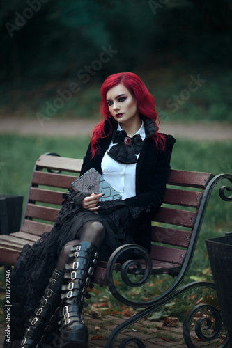 red haired vampire girl in an old Museum in Gothic black clothes and a tailcoat dark book spider