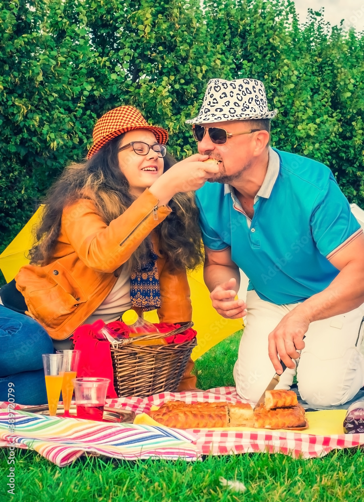 dad, teenage daughter on the picnic in the park outdoors. The concept