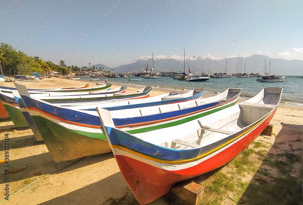 Amazing colored bots in the beach in Ilha Bela, Sao Paulo, Brazil. Summer day, beautiful beach , cool island