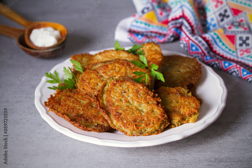 Potato cakes. Vegetable fritters, pancakes, latkes on white plate Potato cakes. Vegetable fritters, pancakes, latkes on white plate
