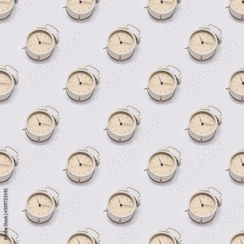 Alarm clock on the background seamless pattern