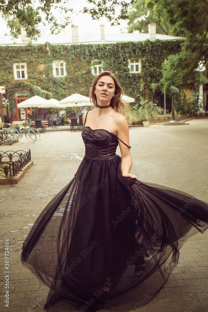 Fototapeta premium a girl runs down the street of the old city