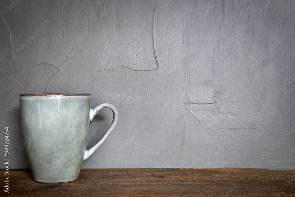 Ceramic mug with white foam gray natural stone design with concrete wall background, coffee or tea concept,copy space Ceramic mug with white foam gray natural stone design with concrete wall background, coffee or tea concept,copy space