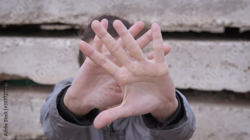 Stop aggression. A view of an offended woman showing a stop gesture. photo