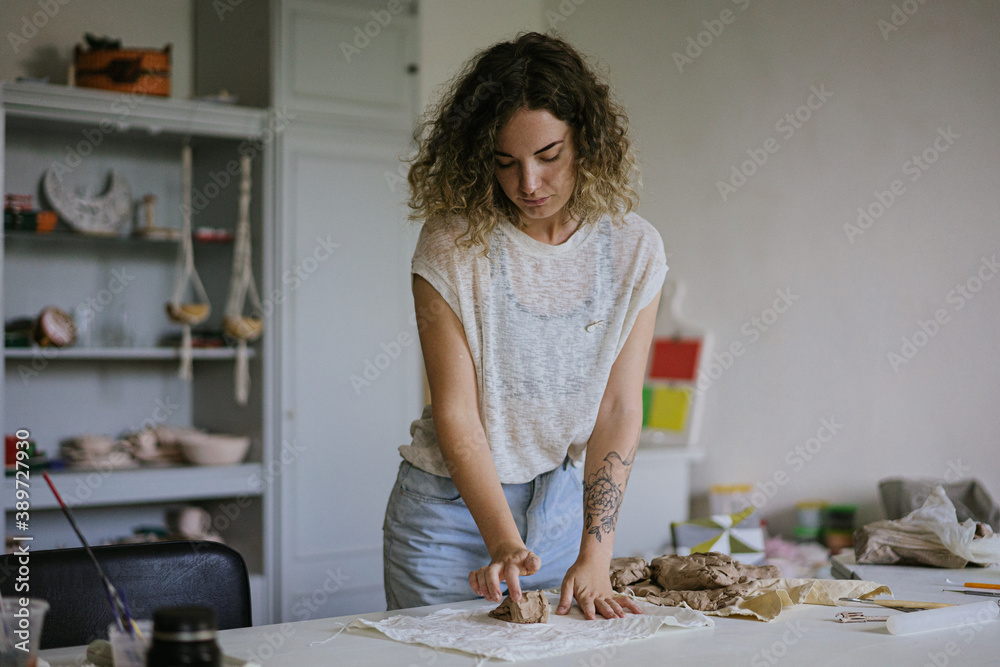 young curly girl in a pottery workshop makes a vase young curly girl in a pottery workshop makes a vase