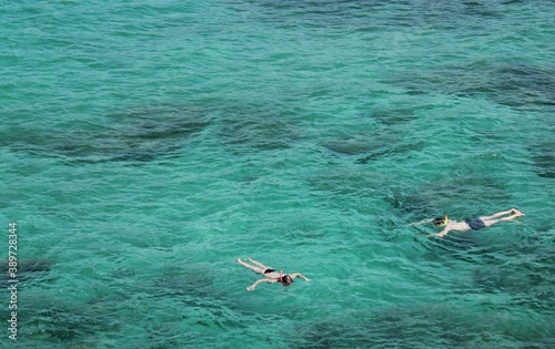 Two people snorkeling in turquoise-coloured Mediterranean water off coast of Majorca, Spain
