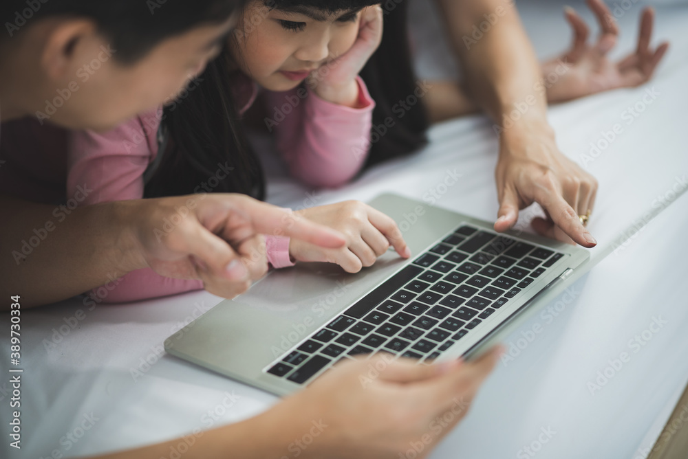 Asian father and mother teaching daughter homework, Parents helping their daughters with homework at home Asian father and mother teaching daughter homework, Parents helping their daughters with homework at home