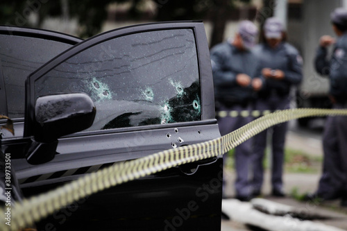 Vászonkép Bullet holes are seen in the window of a car after a armed robbery shot in Sao Paulo, Brazil