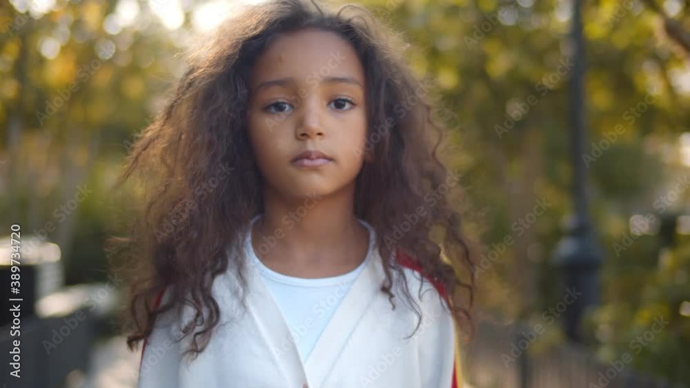 Portrait of beautiful mixed race kid on landscape background