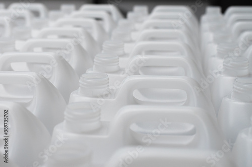 Rows of white plastic canisters ready to be filled with chemicals
