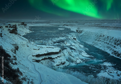 
Snowy landscape at night at Gullfoss Falls with Northern Lights in Iceland during Christmas
 photo