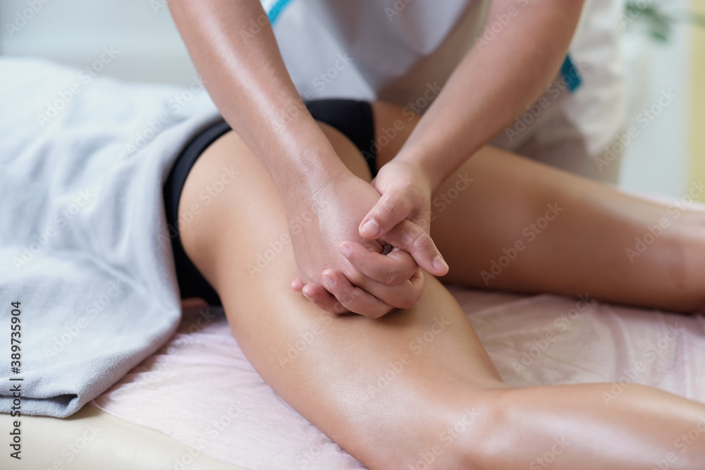 Caucasian woman getting a leg massage in the spa salon. Body care concept. Caucasian woman getting a leg massage in the spa salon. Body care concept.