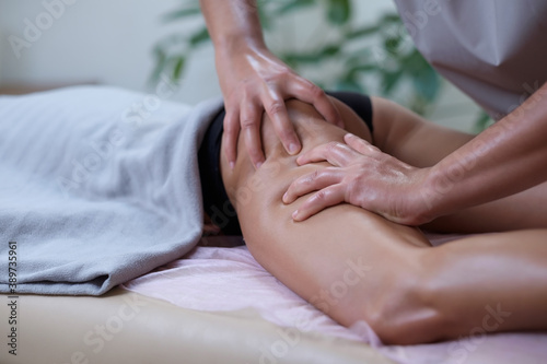 Caucasian woman getting a leg massage in the spa salon. Body care concept.
