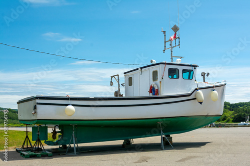 Leinwand Poster Fishing boat  - Fishing boat docked on dry land  on Cape Breton Island, Nova Scotia, Canada