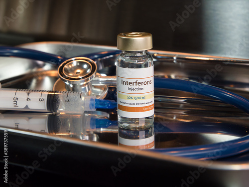 Vial of interferons injection with stethoscope and syringe photo