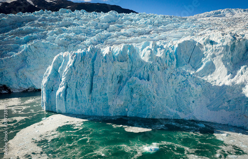 Glacial terminus over turquoise ocean 