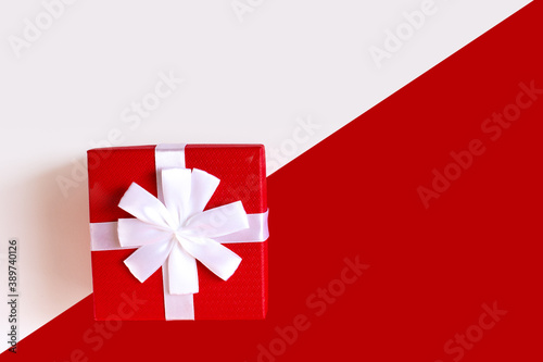 Red and white diagonal paper texture, red gift box with white bow