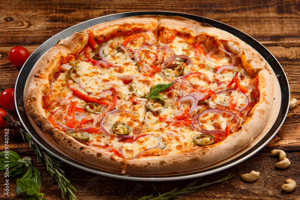 Pizza with holopeno, onion and cheese on wooden background