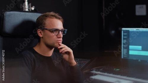 Person working on computer in music studio photo