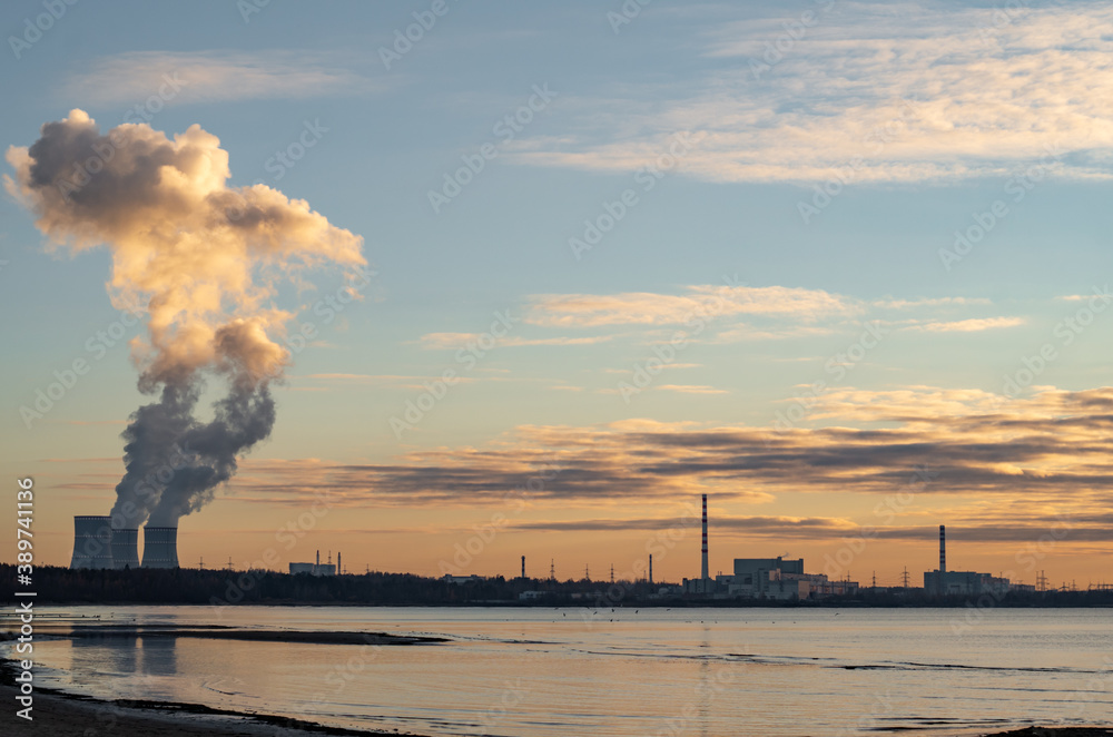 Nuclear power plant on the Bay, sunset.The concept of the peaceful atom
