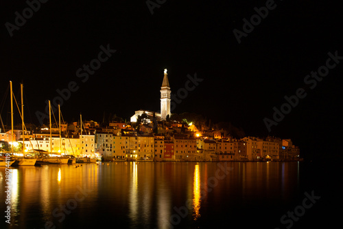 Rovinj Istria Croatia.View of night city situated on the coast of Adriatic Sea.Popular tourist resort and fishing port.Old town with cobblestone streets  colorful houses and Church of St. Euphemia.