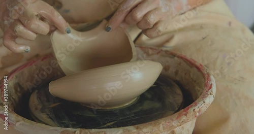 Close up of womans hand work with clay in pottery studio