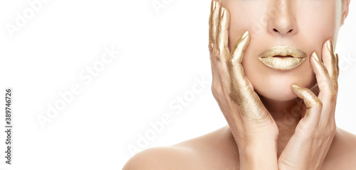Gold based skincare concept. Beautiful model girl with gold treatment on a flawless skin