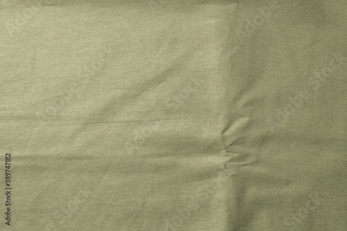 Linen tablecloth, background for text, green, olive color. Fabric texture