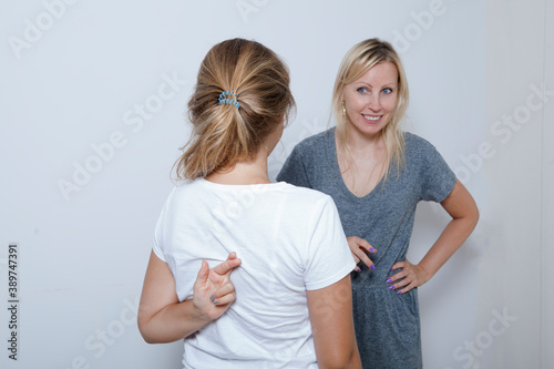 Mother asking her teenage daughter. Girl wants to lie to her parent and crossed her fingers. photo
